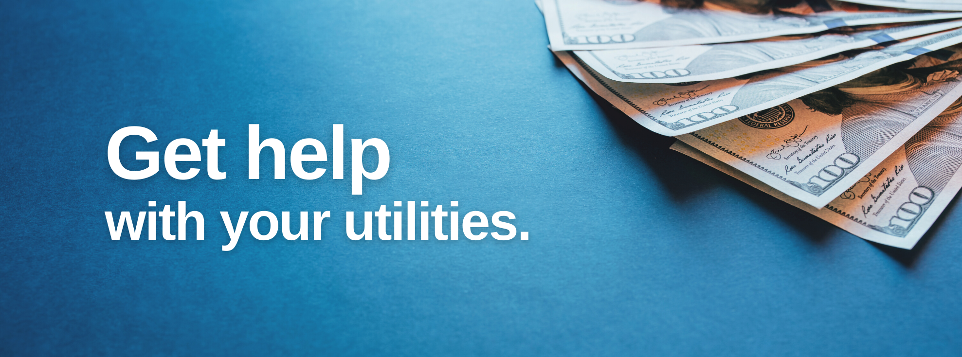 Money fanned out on a surface with text that reads 